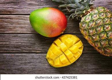 Mango With Pineapple On Wooden Background