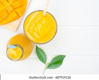 Mango Smoothie With Diced Mango And Leaves Top View.