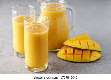 Mango smoothie in glasses. Fresh breakfast, detox drink