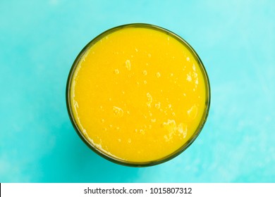 Mango Smoothie, Juice On Blue Background. Copy Space. Top View.