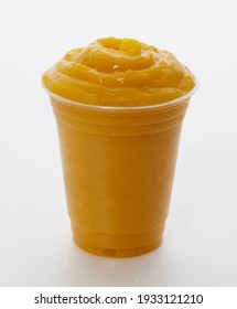 Mango Smoothie Or Shake In A Plastic Cup On A White Background
