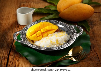 Mango sticky rice (Kwao Neaw Ma-Moung) on wooden table and decoration with Thai style, popular Thai tradition dessert dish - Shutterstock ID 2148939311