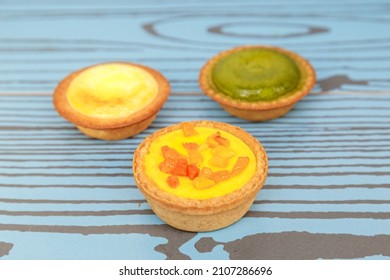 Mango Tart, Egg Tart And Steamed Custard Tart On A Wood With Copy Space.