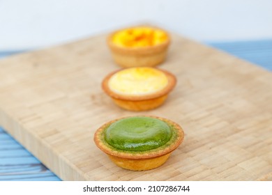 Mango Tart, Egg Tart And Steamed Custard Tart On A Wood With Copy Space.