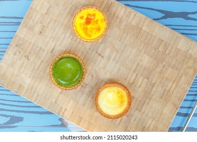 Mango Tart, Egg Tart And Steamed Custard Tart On A Wood With Copy Space. Top View.