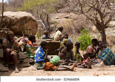 MANGOLA, TANZANIA - AUGUST 14: A hadzabe women with their childrene, only about 1000 people of this tribe are left, they still live in the old way August 14, 2015 in Mangola, Tanzania