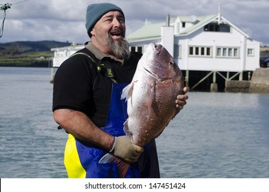 MANGONUI, NZ - JULY 25 2013: Happy Fisherman Holding A Very Large Snapper. NZ Exclusive Economic Zone Covers 4.1 Million Km2,It's The 6th Largest Zone In The World And 14 Times The Size Of NZ.