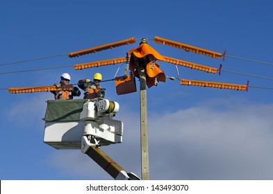 MANGONUI,NZ - JUNE 11 2013:Two Power Line Technicians Repairs Power Pole.NZ Electricity Sector Uses Mainly Renewable Energy Sources Such As Hydro Power,geothermal Power And Increasingly Wind Energy