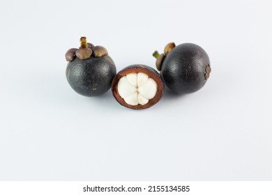 Mangosteen Fruits,see Inside, Placed On A White Background.