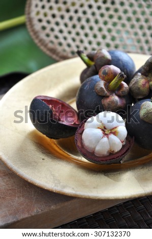 mangosteen on golden plate with asian style background