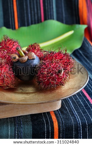 mangosteen with rambutan fruits on plate