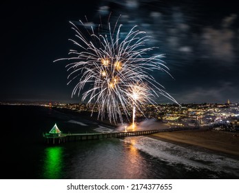 Manhattan Beach Pier In California At Night With Fireworks Overhead.