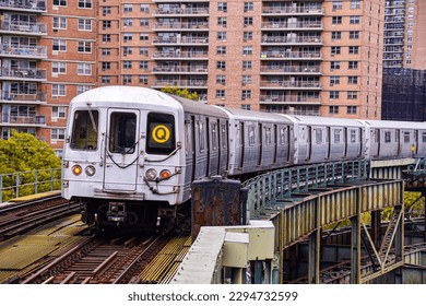 A Manhattan bound Q train curving away from West Eighth Street- NY Aquarium consisting of R46 subway cars