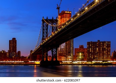 Manhattan Bridge illuminated at dusk very long exposure for a perfectly smooth water