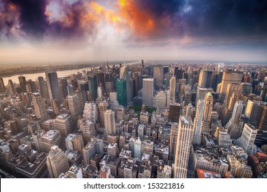 Manhattan, New York City. Sunset in June shines over skyscrapers.
