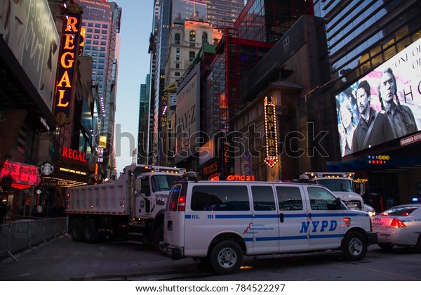Manhattan,\
New York, December 31, 2017: Theater District next to Times Square\
with NYPD car and trucks on West 42nd\
street
