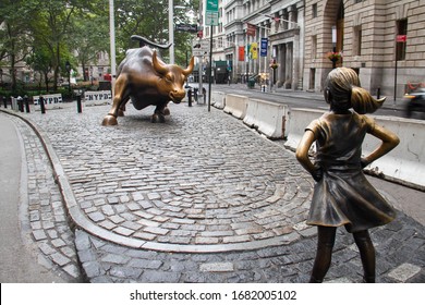 Manhattan, New York, September 11, 2018: Charging bull and the fearless girl statues at Wall Street