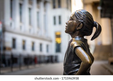 Manhattan, New York, USA - 4/25/2020: Bronze Statue Titled Fearless Girl, Stands Facing The New York Stock Exchange On Broad And Wall Street In NYC. Bronze Sculpture By Kristen Visbal