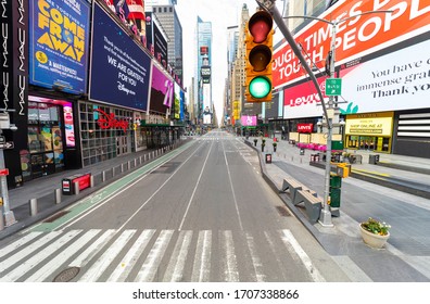 Manhattan, New York, USA - April 12, 2020: Close Up Of Of Traffic Light And High Angle Street View Of An Empty Of Life Times Square During The  Coronavirus / Covid-19 Pandemic In New York City. 