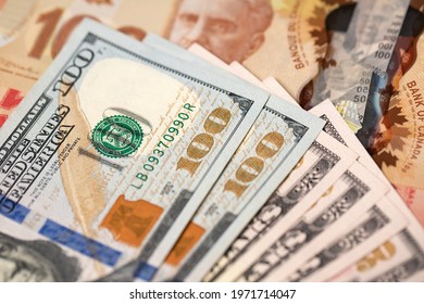 Manhattan, New York, USA - April 8. 2021: US Dollar Bills On Canadian Dollar Banknotes. Exchange Currencies