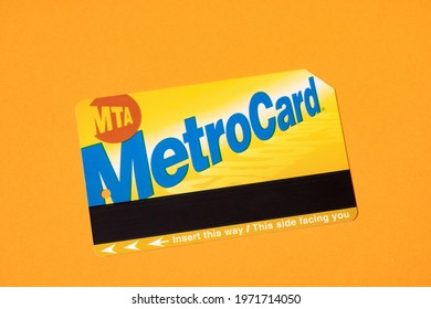 Manhattan, New York, USA - April 8. 2021: New York City Metrocard On Orange Background. Ticket For Public Transit In NYC