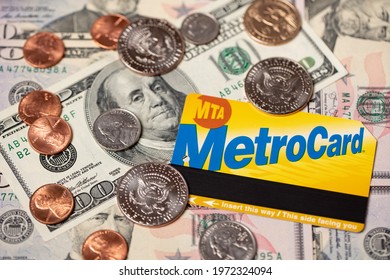 Manhattan, New York, USA - April 8. 2021: Metrocard On Dollar Banknotes And US Dollar Coins. Cost Of Public Transit In NYC. Ticket For Subway And Bus.