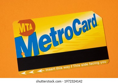 Manhattan, New York, USA - April 8. 2021: New York City Metrocard On Orange Background. Ticket For Public Transit In NYC