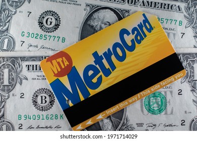 Manhattan, New York, USA - March 26. 2021: NYC Metro Card On One Dollar Bills. MTA Subway And Bus Ticket. Price For Public Transport