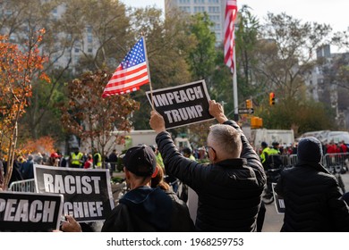 Manhattan, New York, USA - November 11. 2019: Trump protester on Madison square Park in NYC on Veterans Day after Donald Trump speech. Impeach Trump sign