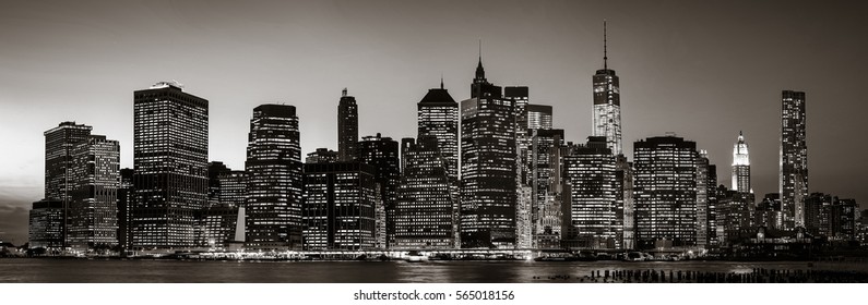 Manhattan at  night. Black and white image of New York City skyline panorama with lights and reflections.