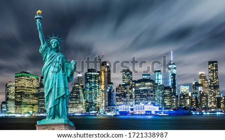 Manhattan panoramic skyline at night. Statue of Liberty with Manhattan background. New York City, USA. 