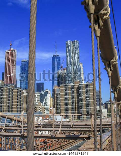 Manhattan Sky Line from the Brooklyn Bridge during\
the summer