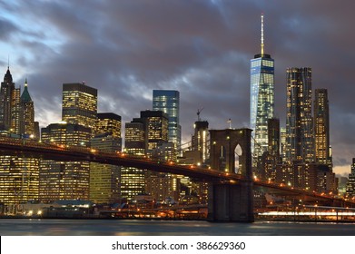 Manhattan Skyline With Brooklyn Bridge At Night.