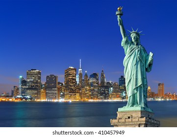 Manhattan skyline at night and Statue of Liberty. - Shutterstock ID 410457949