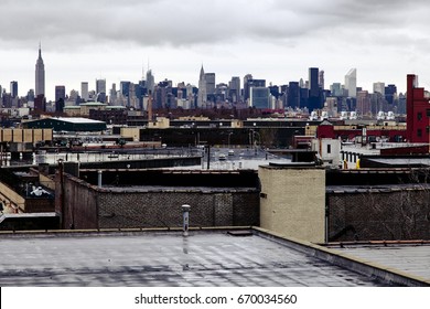 The Manhattan skyline as seen from a Brooklyn rooftop onan inclement day.