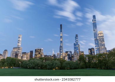 Manhattan skyscrapers and Central Park meadow at sunset - Shutterstock ID 2341082777