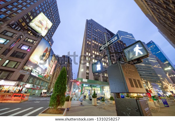 MANHATTAN, USA - NOVEMBER 30th, 2018: City\
streets at sunrise in Times Square area. This district is a famous\
tourist attraction.