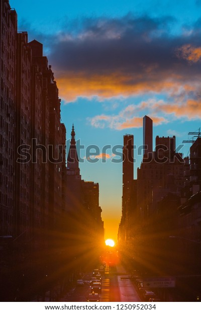 Manhattanhenge  is when the sunrise
perfectly lines up with east-west street on the main street grid in
Manhattan.
Sunrise Manhattanhenge occurs December and
January,