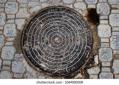 Manhole Cover In Pavement From Above View