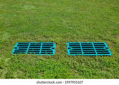 manhole drainage grates on the lawn with green grass septic tank cover, sump cesspool drainage system environment design with copy space, nobody.