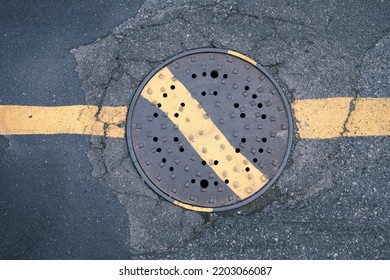 a manhole in the middle of the street
