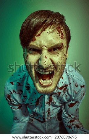 Manic split personality. A psychopathic crazy man, splattered with blood. Horror, thriller.