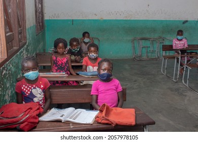 Manica, Mozambique - October 14, 2021: Schoolgirls back to school in a classroom, distanced and wearing face masks, preventing themselves from covid-19.