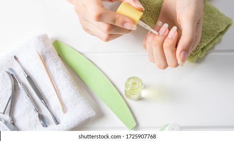 Manicure. Apply cuticle oil to unpainted nails. Moisturizing. Home nail care. Beauty salon, procedure, SPA. Beauty, style, makeup, fashion, lifestyle.