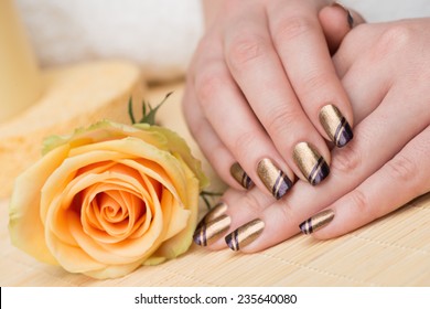 Manicure - Beauty Treatment Photo Of Nice Manicured Woman Fingernails. Very Nice Holiday Nail Art With Nice Gold And Purple Nail Polish. Selective Focus.