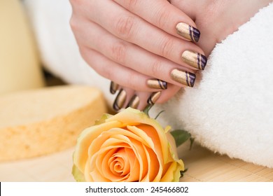 Manicure - Beauty Treatment Photo Of Nice Manicured Woman Fingernails. Very Nice Holiday Nail Art With Nice Gold And Purple Nail Polish. Selective Focus.