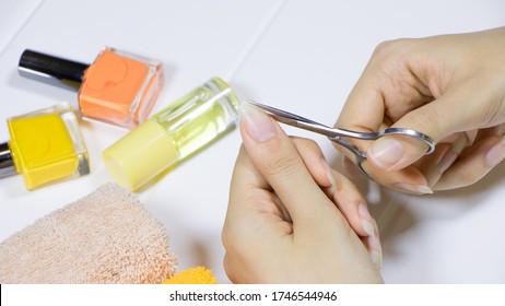 Manicure. Cut your fingernails with small nail scissors. Trim your nails. Young woman taking care of her nails. Hygiene, clipping, cutter, self, skincare, procedure, routine, treatment. - Shutterstock ID 1746544946