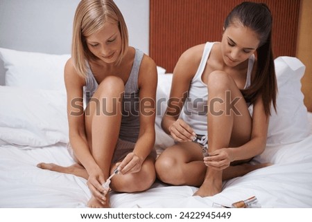 Manicure, female and friends with nail polish, bonding and self care on bed for sleepover together. Sisters, cosmetics and woman connect in bedroom, makeup and beauty talk for wellness and happiness