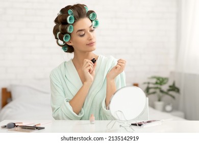 Manicure. Glamorous Housewife Doing Nails Applying Fingernail Polish Sitting In Bedroom At Home, Curling Hair With Curlers. Female Beauty Care Routine. Selective Focus