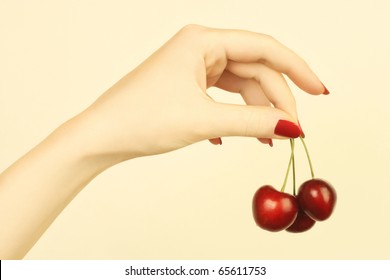 Manicure. Hand With Cherry. Ripe Cherries In The Woman's Hand With Red Nails